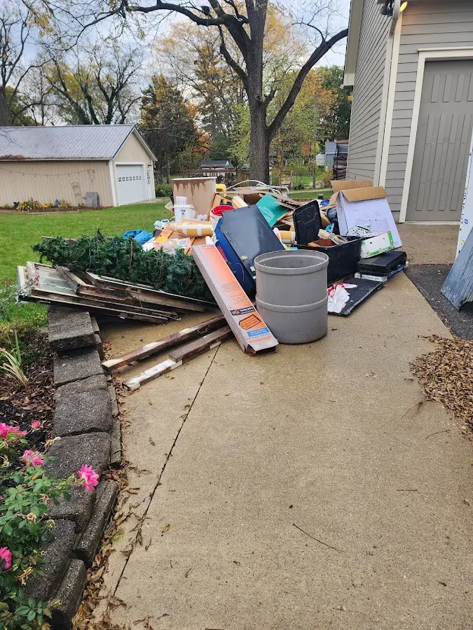 Dumpster being loaded with debris for Estate Cleanout Dumpster Rental in South Haven